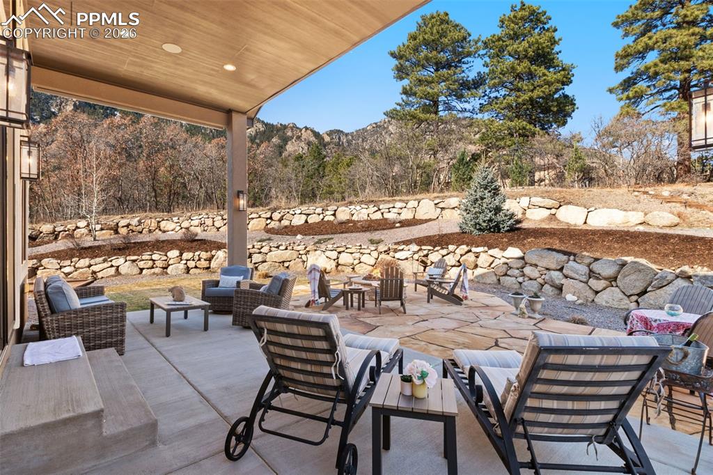 Terraced landscaping perfectly frames the outdoor lounge areas, creating distinct zones for relaxing against the dramatic forested hillside
