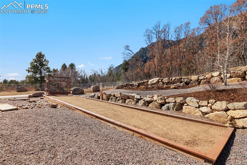 A custom bocce ball court adds an unexpected layer of luxury recreation to the grounds, encouraging active outdoor living and friendly competition among guests
