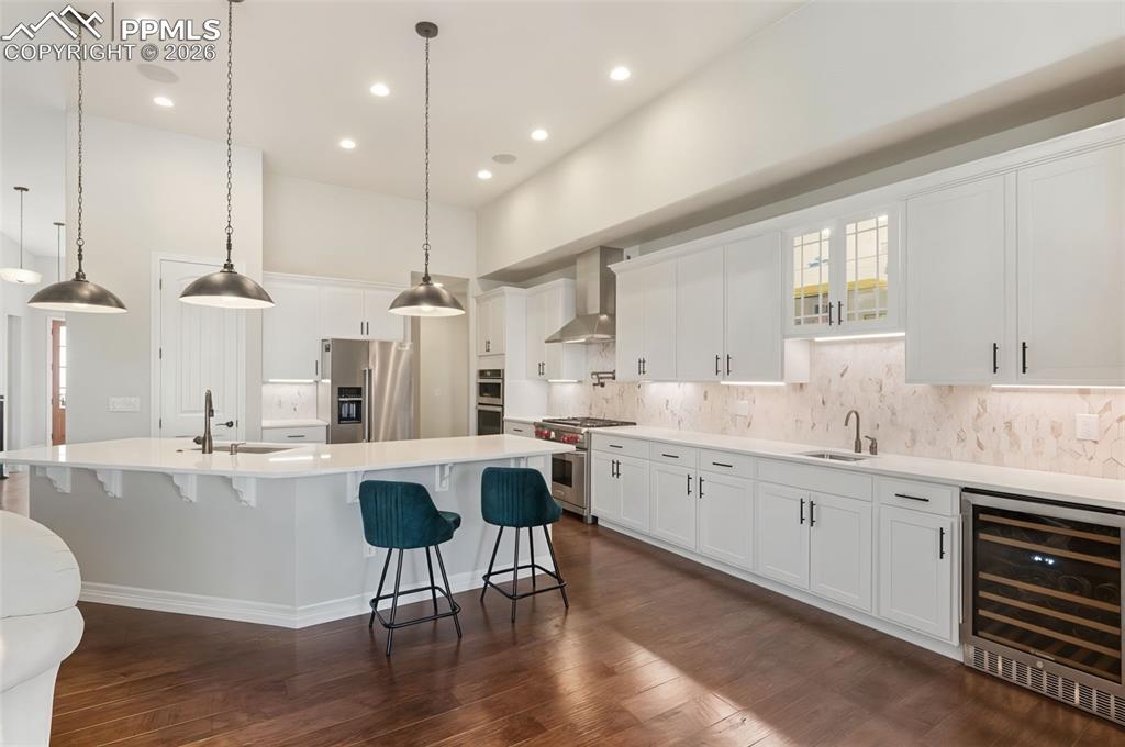 A true culinary workspace, this layout boasts extensive counter space, under-cabinet lighting, and an under-counter wine fridge to keep vintages at the perfect temperature for immediate serving
