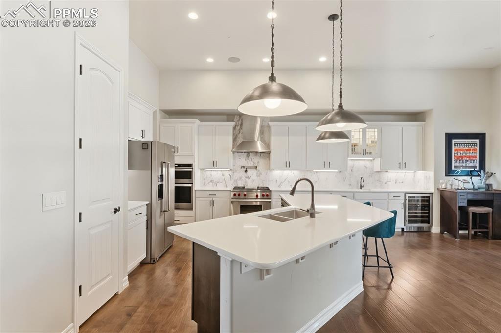A true culinary workspace, this layout boasts extensive counter space, under-cabinet lighting, and an under-counter wine fridge to keep vintages at the perfect temperature for immediate serving
