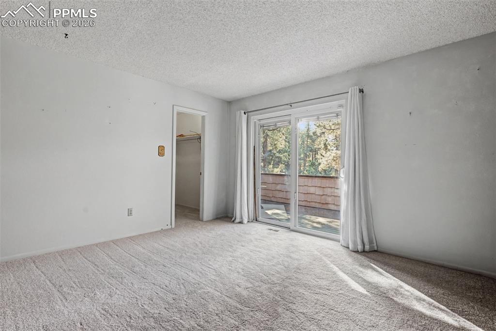 Main level bedroom with walk out to upper front deck