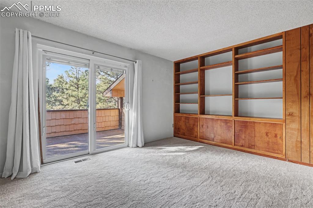 Upper 2nd bedroom with Aspen paneling and built ins 