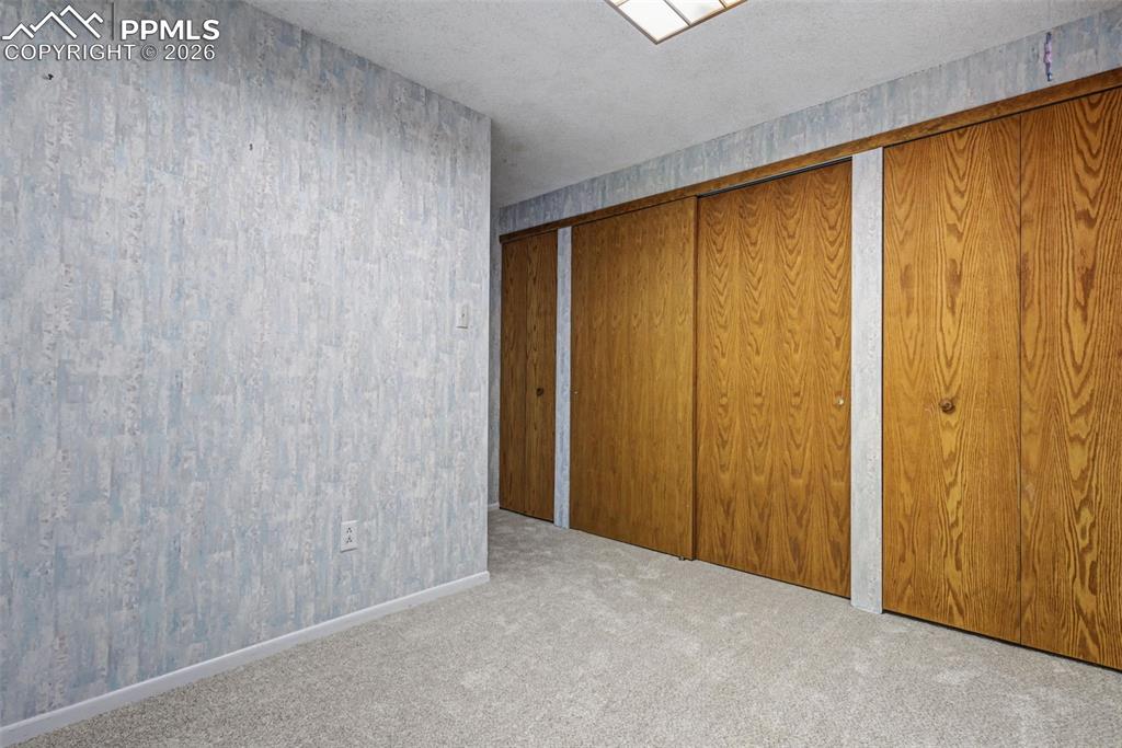 Smaller lower level bedroom with four closets!