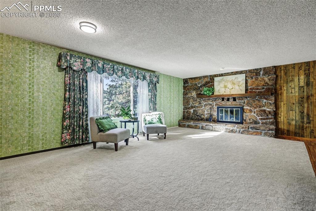 Enormous living room with moss rock fireplace