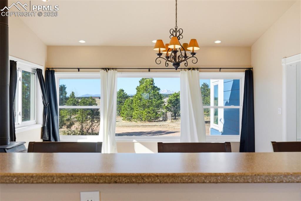 Dining area with a chandelier and views of Pikes Peak