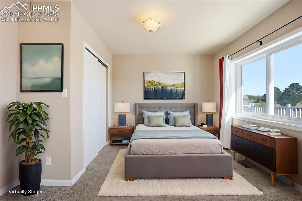 Virtually staged main level bedroom or office, with a closet and carpet