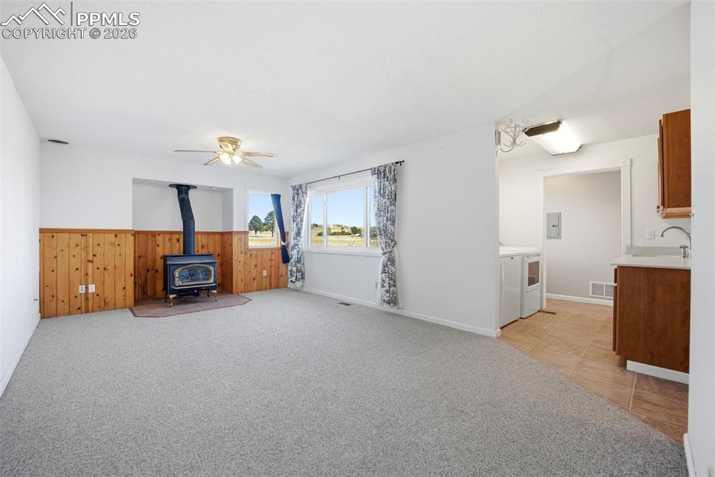 Family room with wood stove and wainscoting
