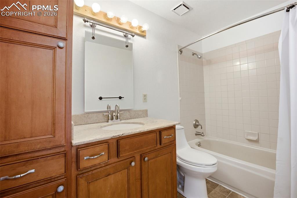 Upper full bathroom featuring vanity, and shower / bathtub combination
