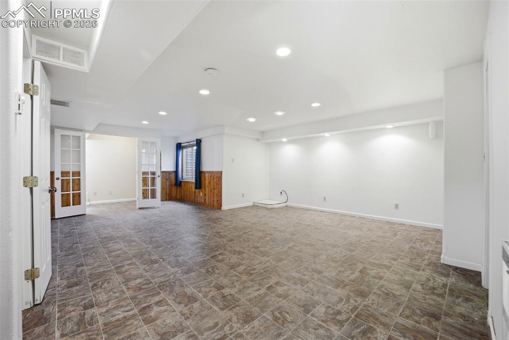 Large basement area with small office area with french doors