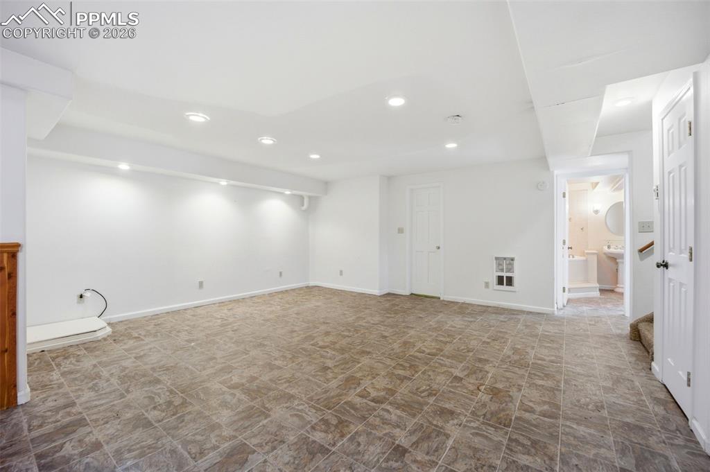 Large basement area with small office area with french doors