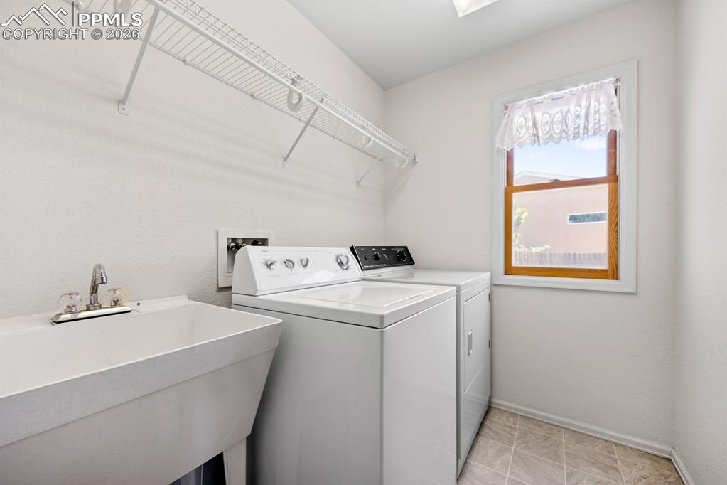 Laundry area featuring baseboards and washer and dryer