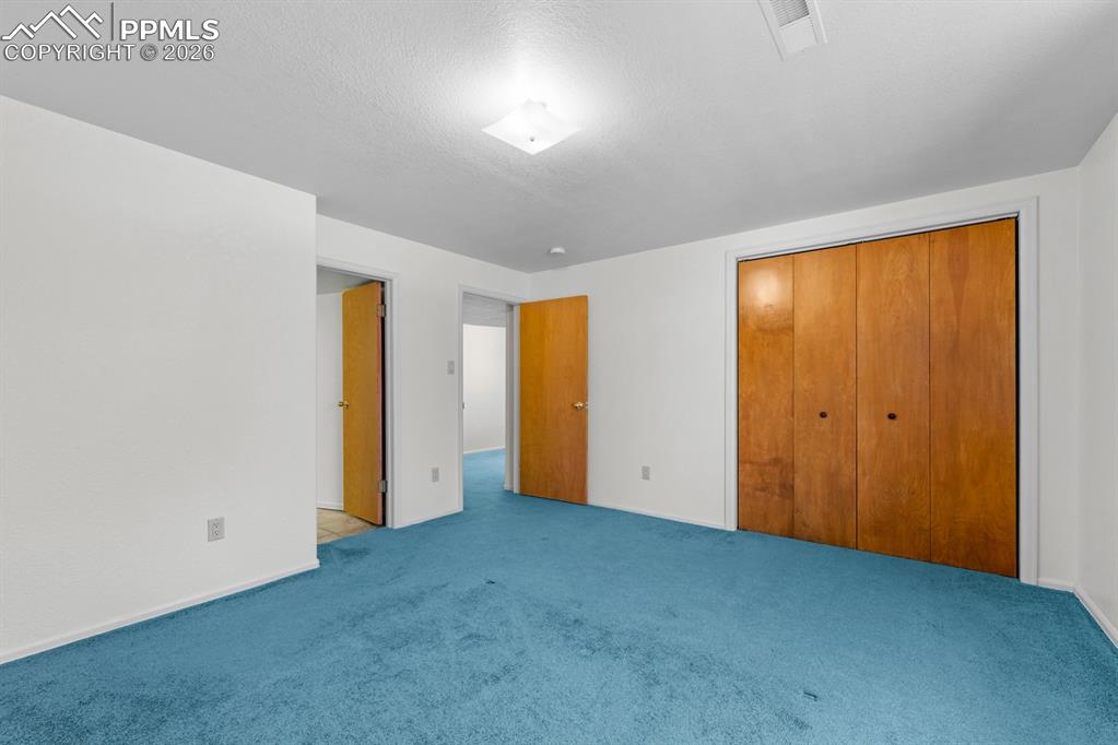 Unfurnished bedroom featuring a closet and carpet flooring
