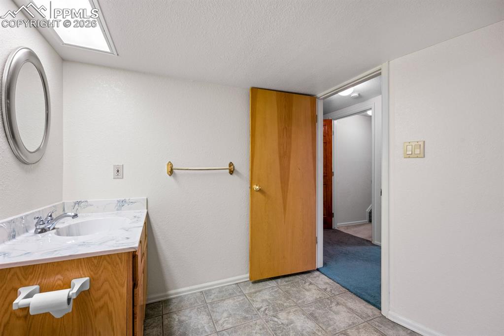 Bathroom with vanity and a textured ceiling