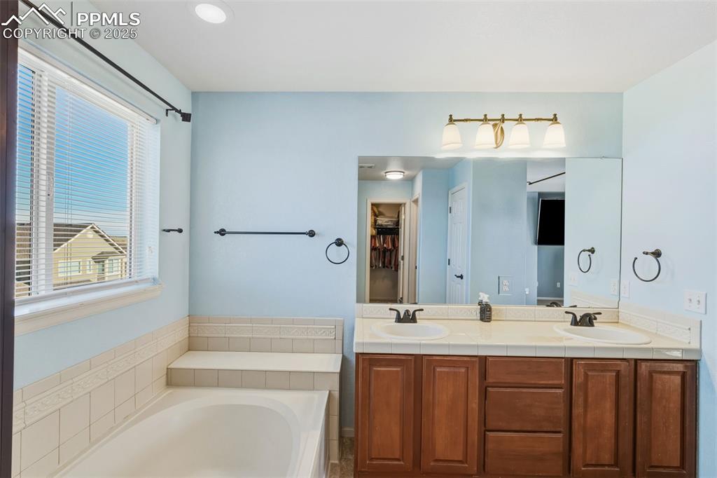 Full bath with double vanity and a bath