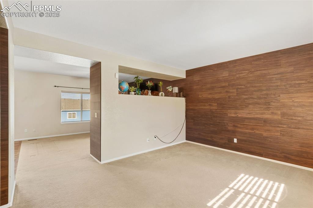 Empty room with wooden walls and carpet