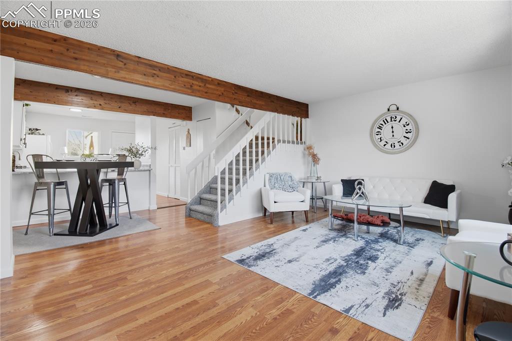 Open floor plan, dining room and kitchen, wood beams, fresh paint. 