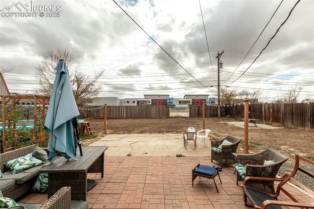 Fenced backyard with a patio and an outdoor living space