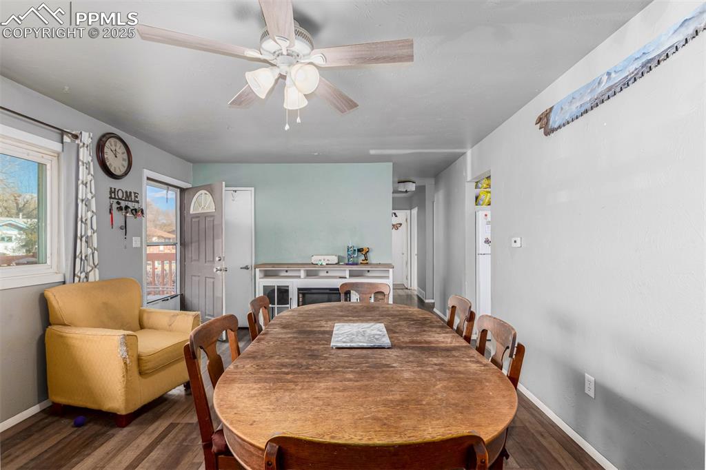 Dining area with wood finished floors and ceiling fan