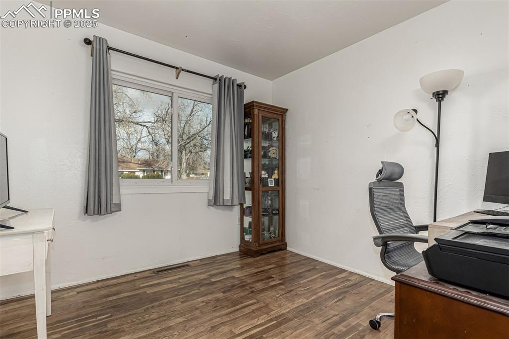 Office space with dark wood finished floors and baseboards