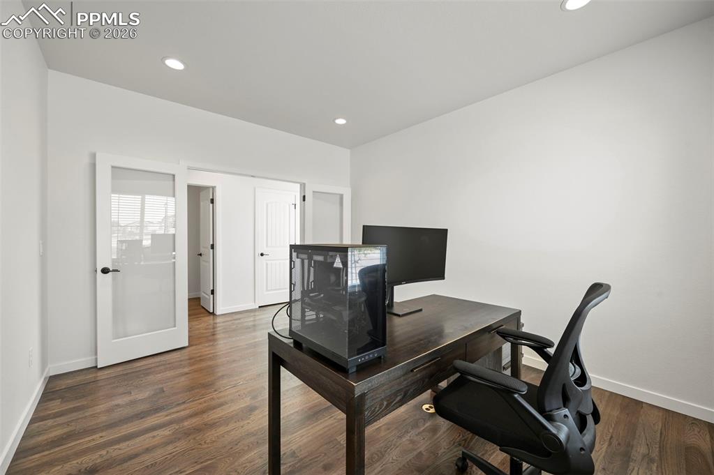 Home office featuring wood finished floors and recessed lighting