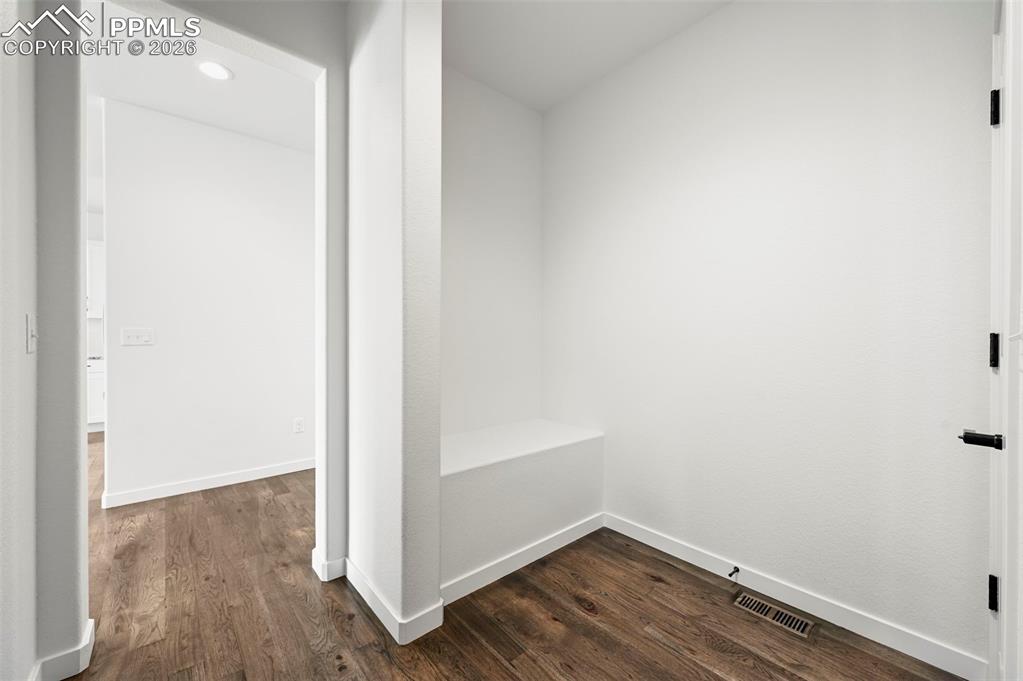 Hallway featuring dark wood-type flooring and recessed lighting