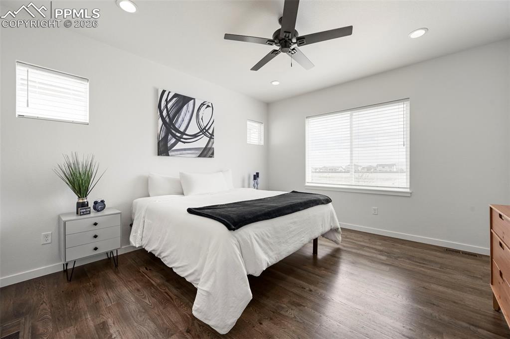Bedroom featuring dark wood-type flooring, recessed lighting, and ceiling fan