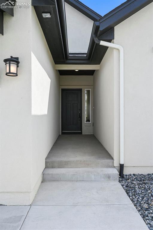 Doorway to property with stucco siding