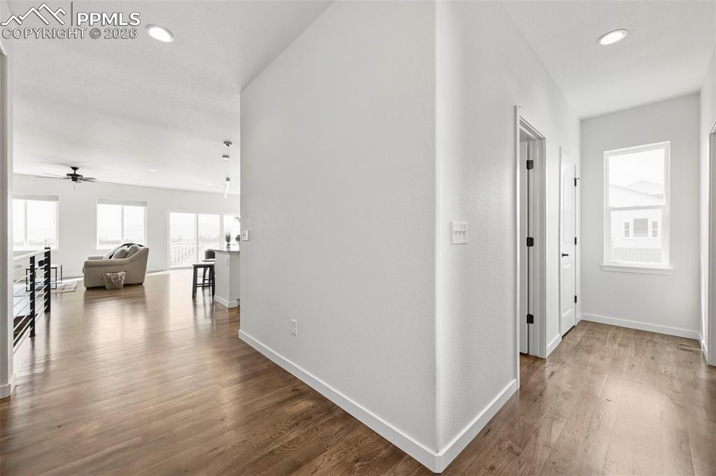 Hallway featuring wood finished floors and recessed lighting