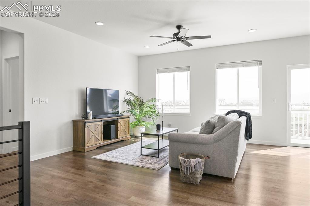 Living area featuring a ceiling fan, dark wood finished floors, and recessed lighting