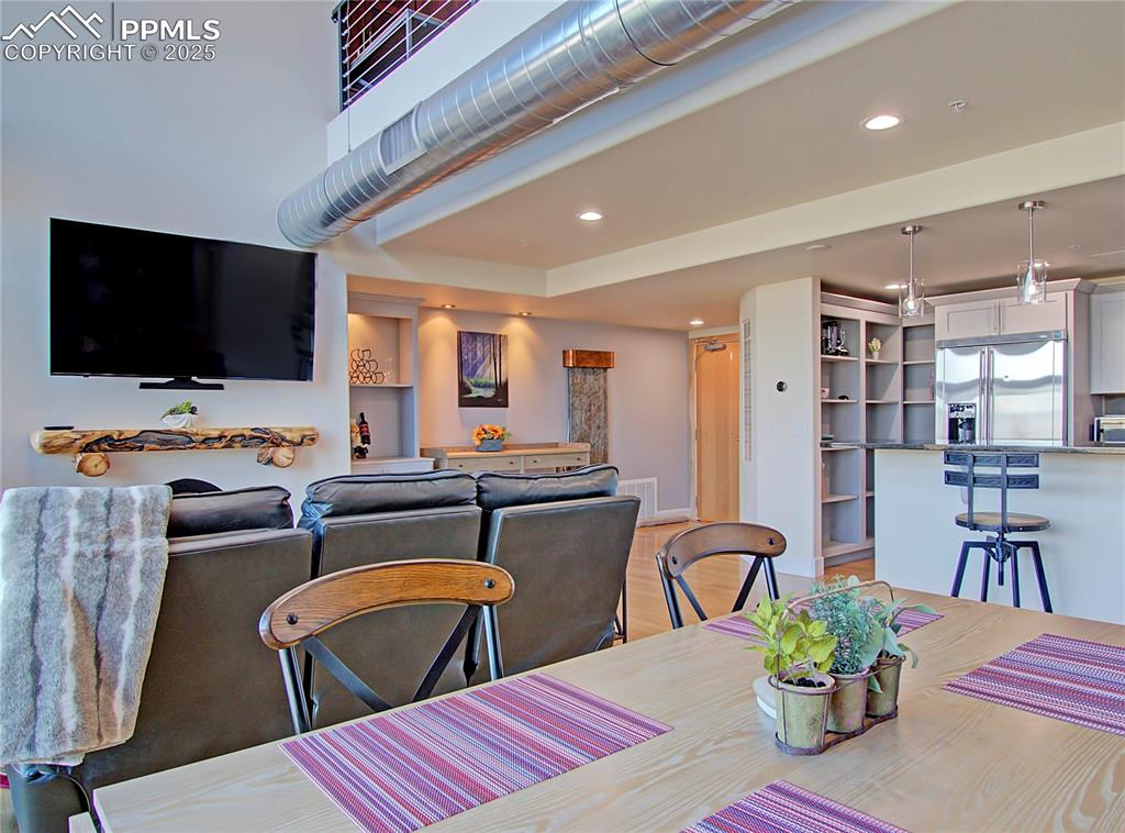 Dining room with recessed lighting and light wood finished floors