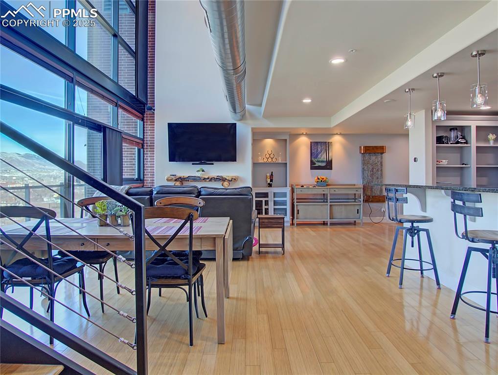 Dining space with light wood-type flooring and recessed lighting