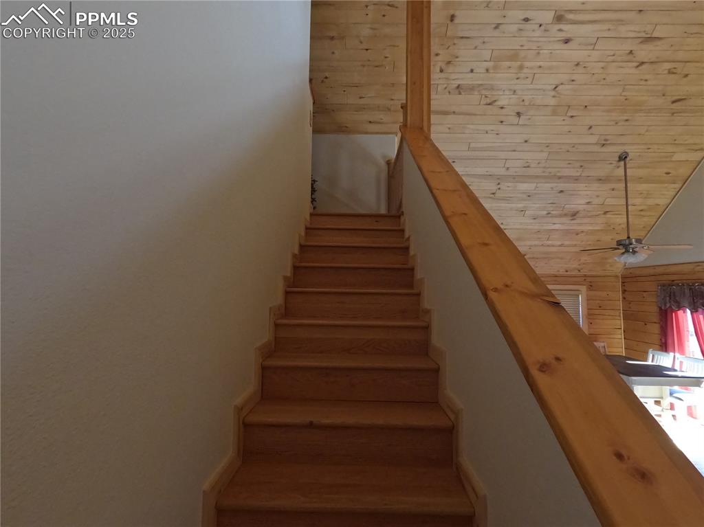 Staircase featuring ceiling fan