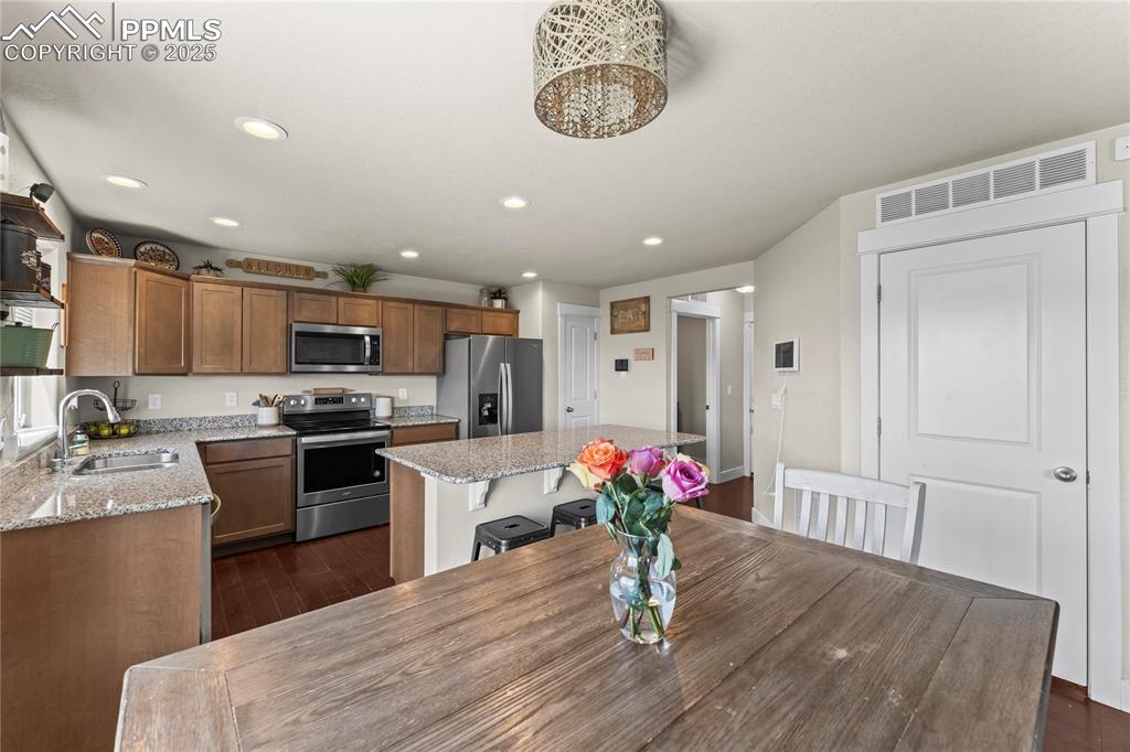 Dining space featuring recessed lighting and dark wood finished floors