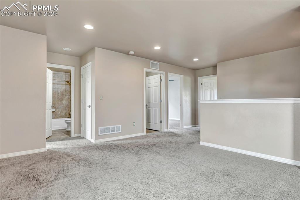 Unfurnished room featuring light colored carpet and recessed lighting
