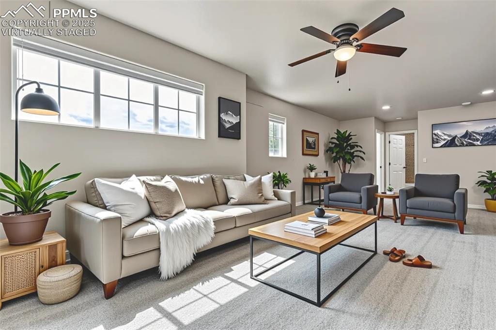 Virtually Staged - Living area featuring a ceiling fan, recessed lighting, and carpet flooring