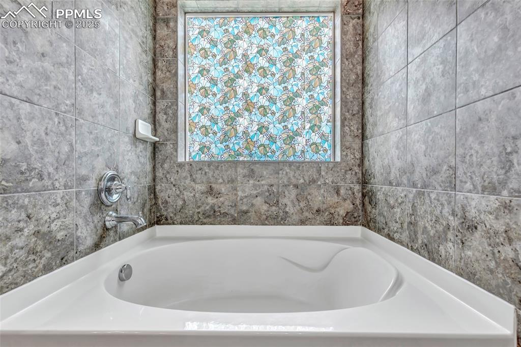 Master bathroom featuring a bath