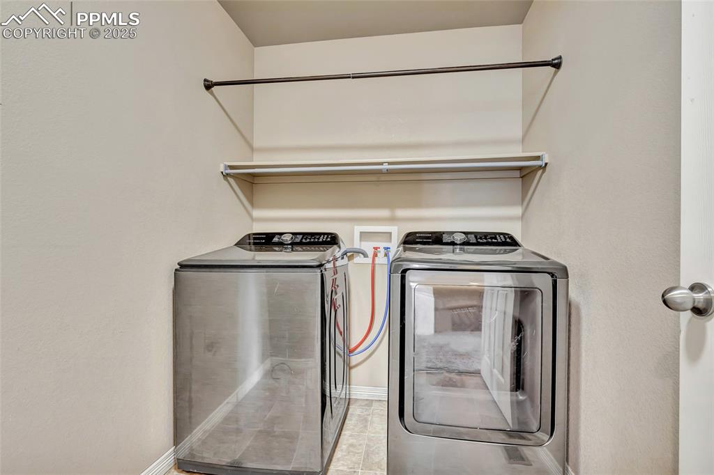 Upper level laundry room with washer and room for storage/folding