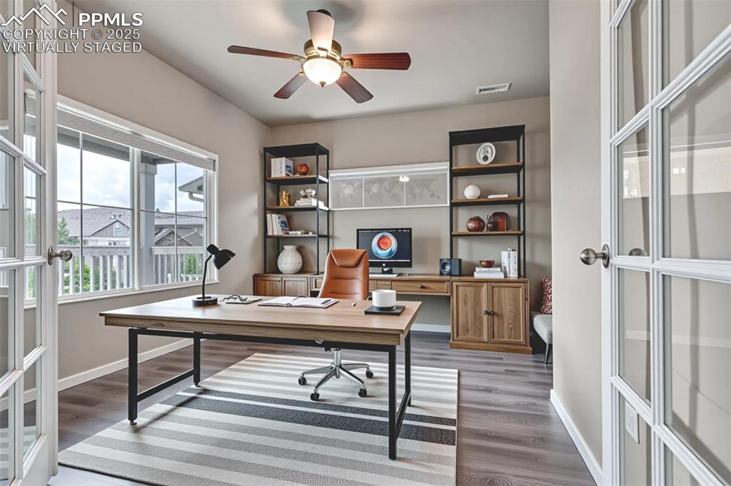 Virtually Staged - Office featuring french doors, ceiling fan, and light wood finished floors