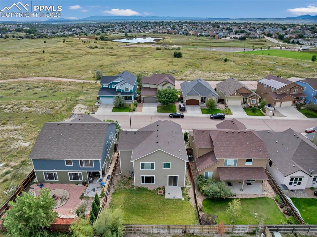 Aerial perspective of suburban area with a water and mountain view