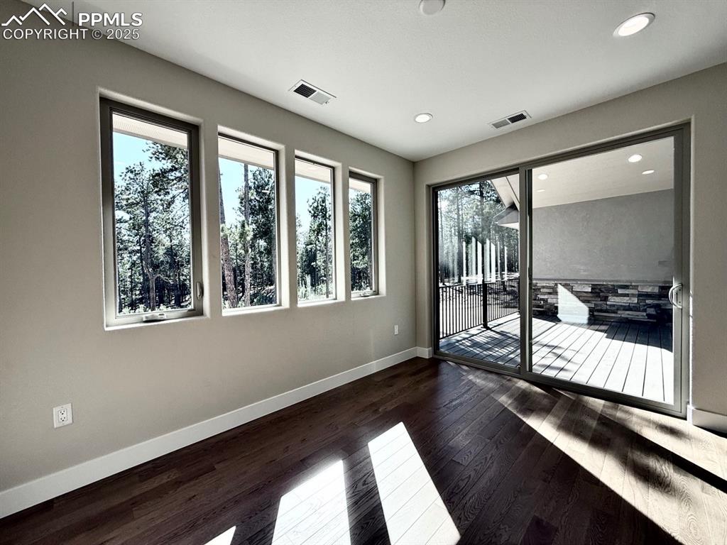 Formal Dining Room with access to the Covered Deck and Wood Flooring.