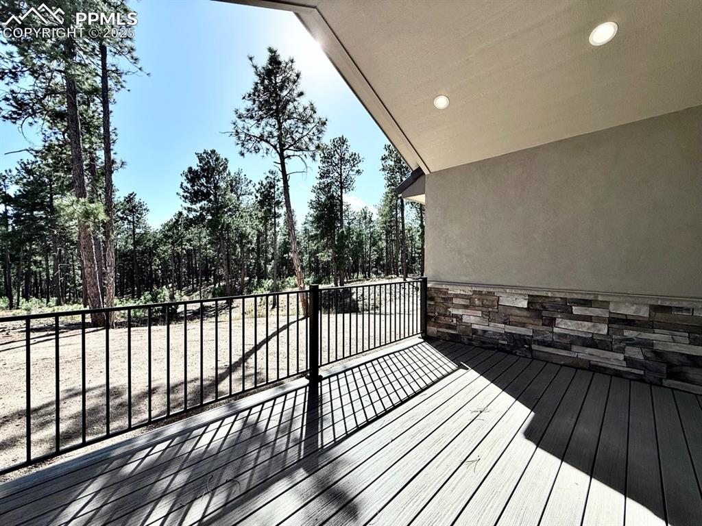 Oversized Sliding Doors to the Covered Composite Deck, featuring Natural Gas Line for Grilling and a Hose Bib for watering your favorite plants as you gaze into the forest.