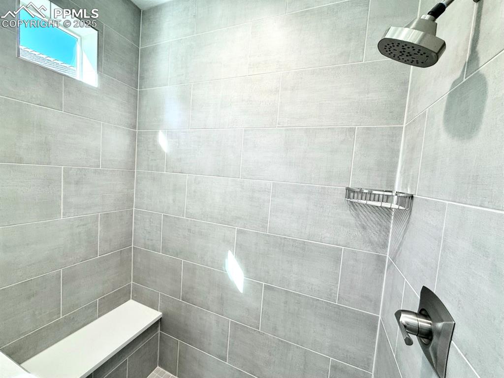 Luxurious Primary Bathroom with Double Vanities, Quartz Countertops, Heated Mirror to avoid Fogging, Deep Soaking Tub, Large Shower with Bench and Glass Door.