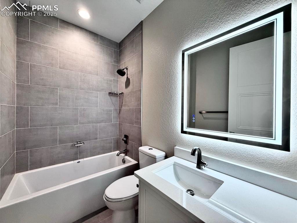Full Bathroom with Deep Soaking Tub and Shower Tiled to the Ceiling. Quartz Countertop and Heated Mirror to avoid Fogging.